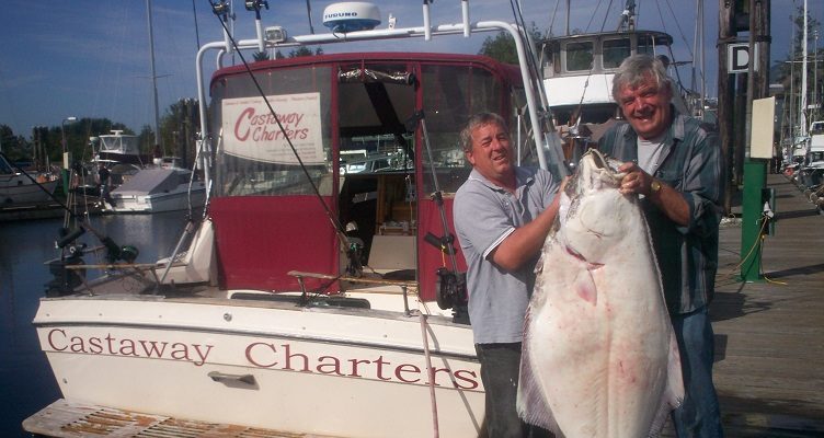 Paul holding up a very large halibut